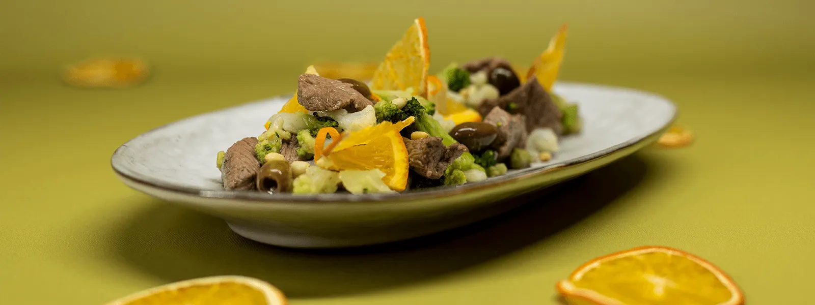 Piatto "Crea Tu" Orogel: straccetti saporiti con olive nere, spicchi d'arancia fresca e pinoli tostati