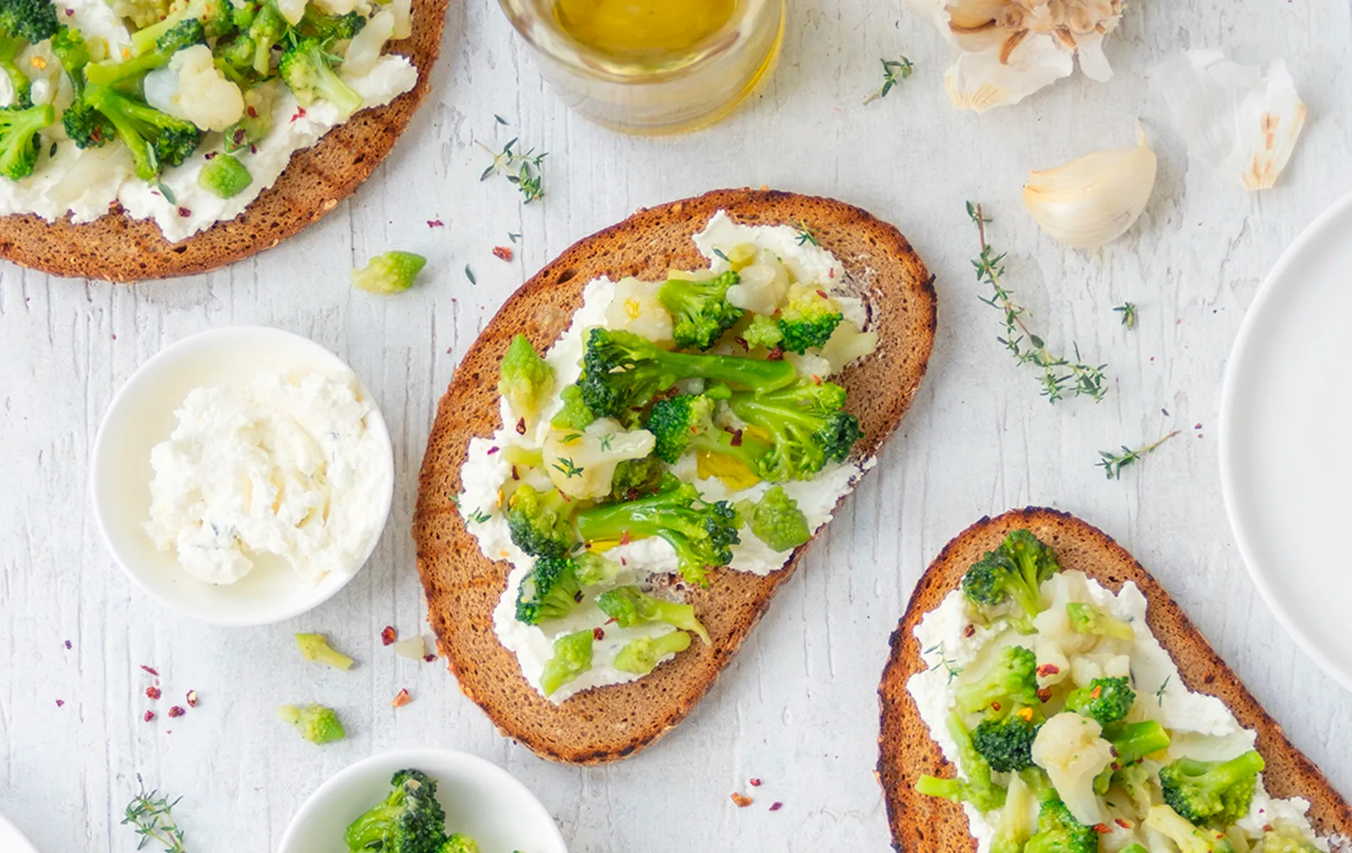 Crostoni con crema di formaggio e broccoli, con olio, aglio ed erbe aromatiche.