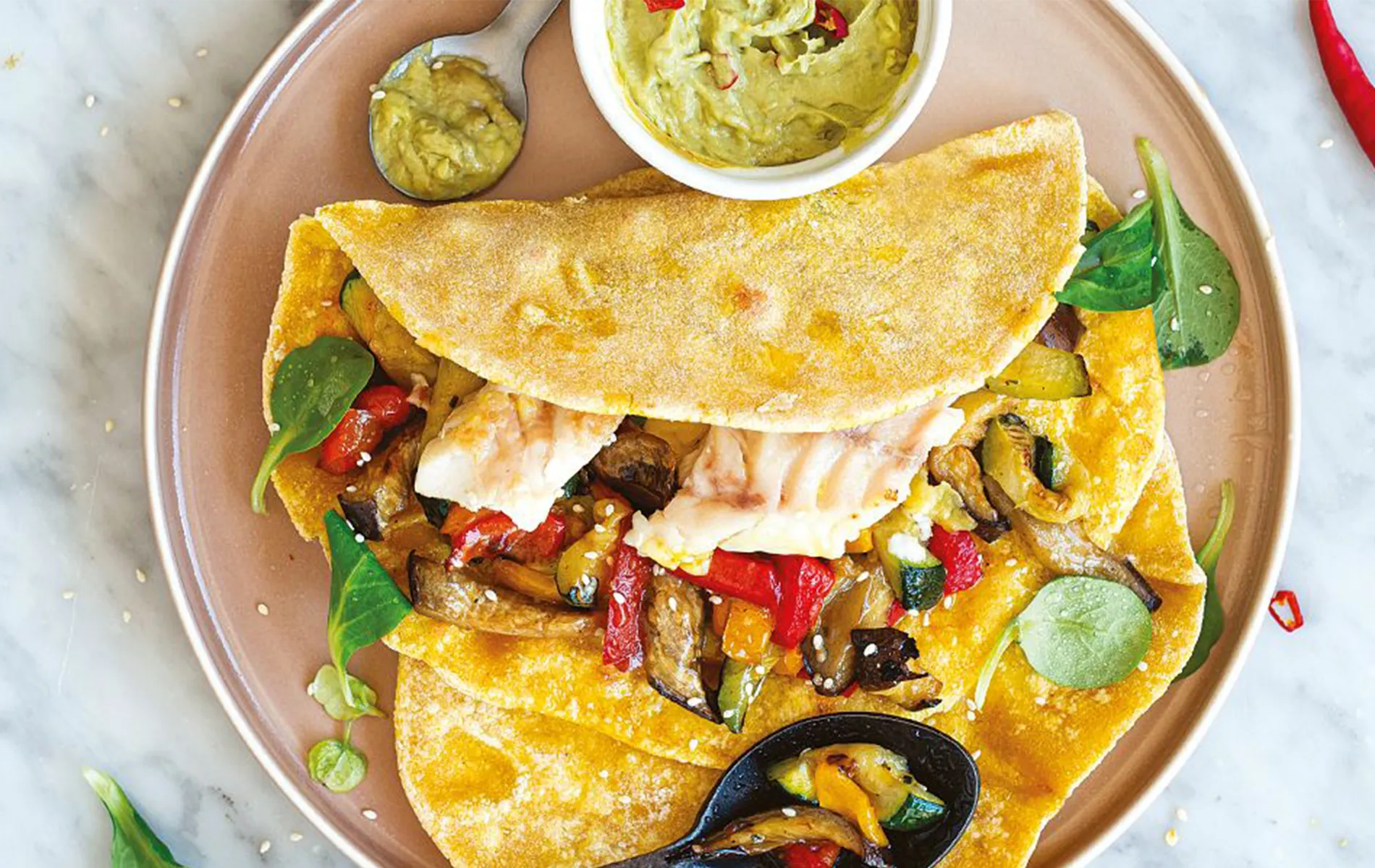 Tacos di pesce con maionese all’avocado, verdure grigliate, lime e peperoncino.